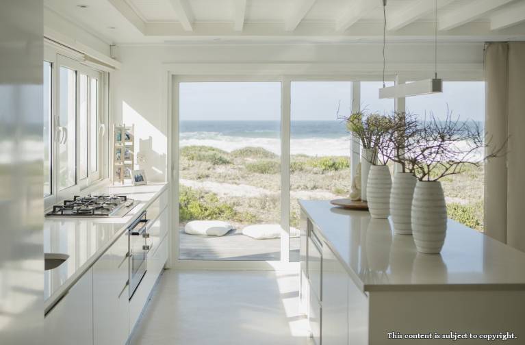 Modern white kitchen with ocean view